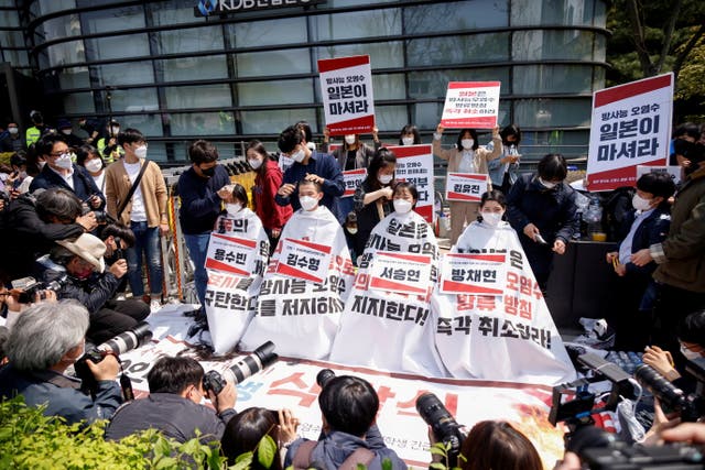 South Korea university students gets their heads shaved during a protest against Japan's decision to release contaminated water from its Fukushima nuclear plant into the sea, in front of the Japanese embassy, in Seoul