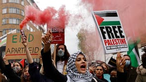 Pro-Palestinian activists and supporters let off smoke flares, wave flags and carry placards during a demonstration in support of the Palestinian cause as violence escalates in the ongoing conflict with Israel, in central London