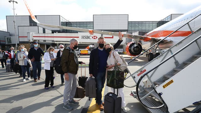 Passengers prepare to board an easyJet flight to Faro, Portugal, at Gatwick Airport after the ban on international leisure travel for people in England was lifted following the further easing of lockdown restrictions in England