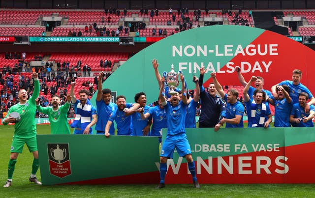 Gary Kenny lifts the Buildbase FA Vase Trophy after Warrington Rylands won the FA Vase Final against Binfield at Wembley Stadium