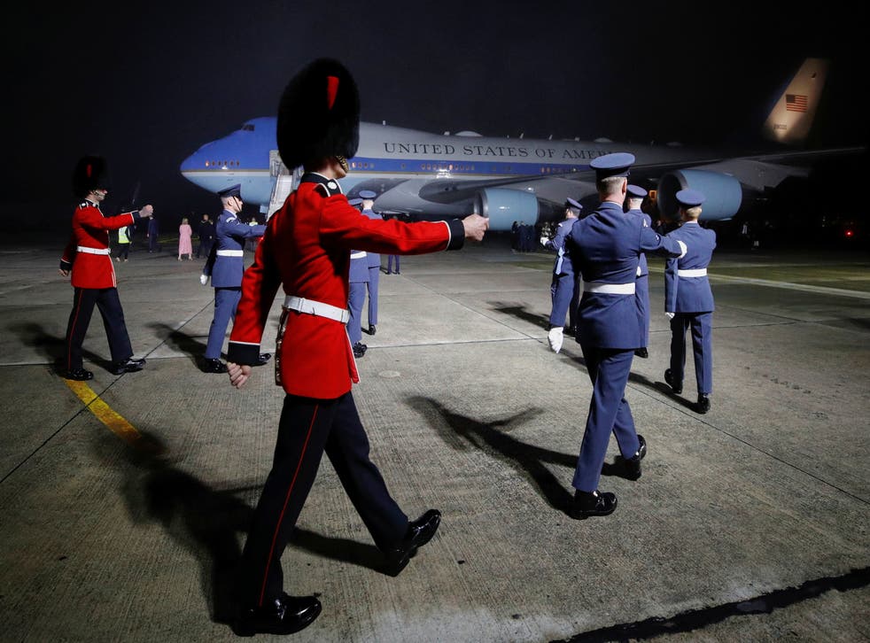 <p>Military personnel march as Air Force One, carrying Joe and Jill Biden arrives at Cornwall Airport Newquay</p>