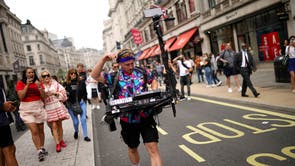 People walk along Regent Street in central London during a #FreedomToDance march organised by Save Our Scene, in protest against the government’s perceived disregard for the live music industry throughout the coronavirus pandemic