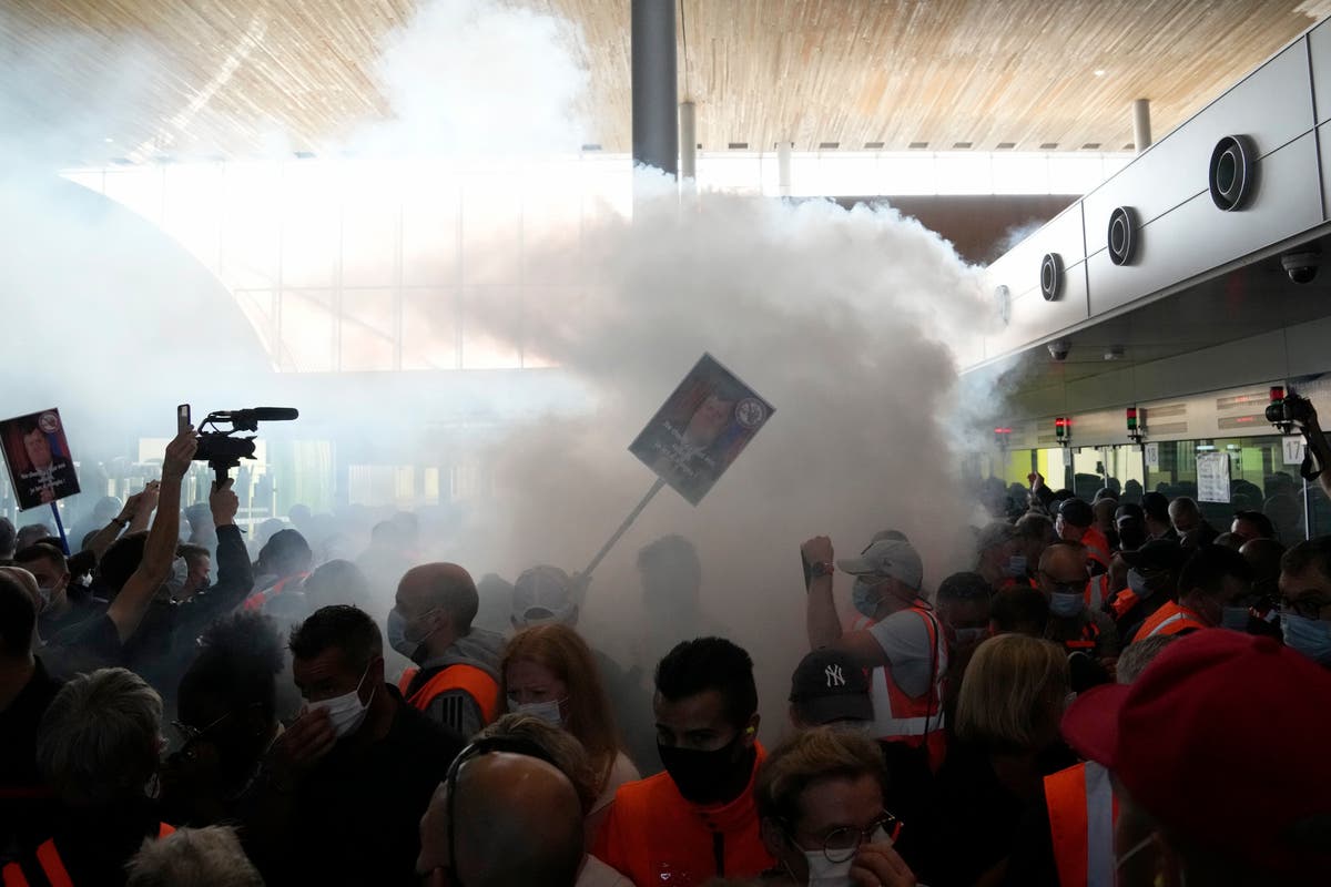 Paris airport workers block terminal to protest pay cut