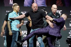 Conor McGregor kicks out at Dustin Poirier in fiery UFC 264 press conference