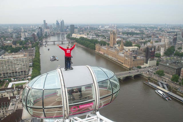 England 1966 World Cup winner Sir Geoff Hurst stands on top of a pod on the lastminute.com London Eye wearing a replica 1966 World Cup final kit and looking out towards Wembley Stadium in the north of the capital, where the England football team will play Italy in the Euro 2020 final on Sunday