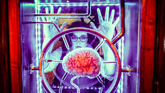 Heidi Street, playing a gothic character, looks at a brain suspended in glass at the world’s first attraction dedicated to the author of Frankenstein inside the ‘Mary Shelley’s House of Frankenstein’ experience, located in a Georgian terraced house in Bath, as it prepares to open to the public on 19 July