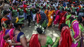 People perform a folk dance to traditional music as they celebrate the International Day of the World's Indigenous Peoples in Mumbai, India