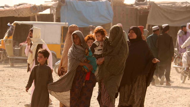 People stranded at the Pakistani-Afghan border wait for its reopening after it was closed by the Talibans, who have taken over the control of the Afghan side of the border at Chaman, Pakistan