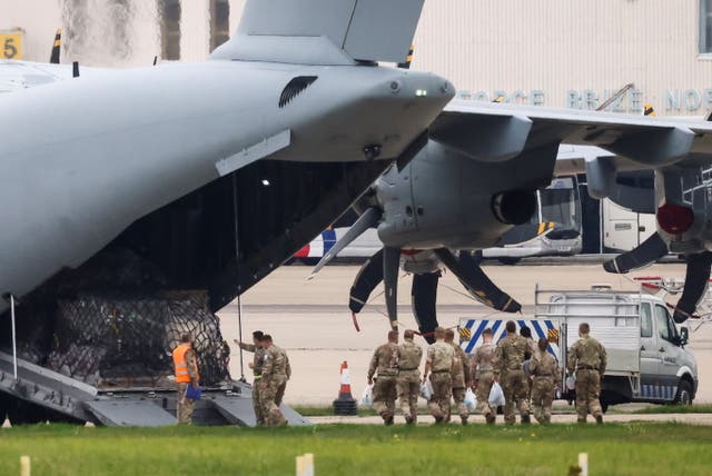 Military personnel board the RAF Airbus A400M at RAF Brize Norton in Oxfordshire, where evacuation flights from Afghanistan have been landing