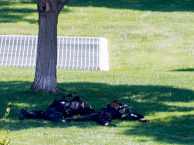 Law enforcement officers with rifles take position near the US Capitol building in Washington DC as police investigate a possible explosive device in a truck near the heart of American government