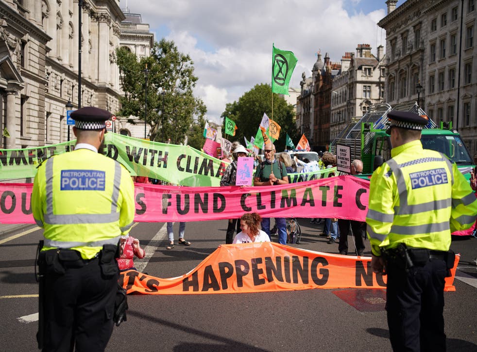 <p>Climate activists from Extinction Rebellion during a protest outside the offices of HM Revenue and Customs (HMRC)</p>