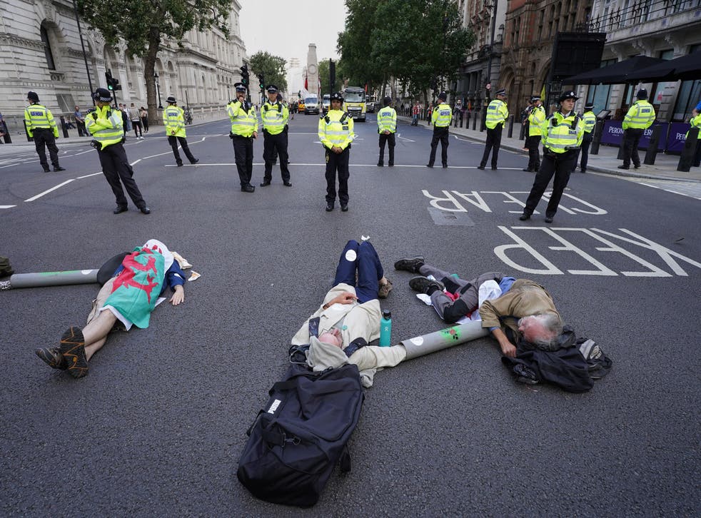 <p>Demonstrators from Extinction Rebellion lay on the floor in Whitehall, London</p>