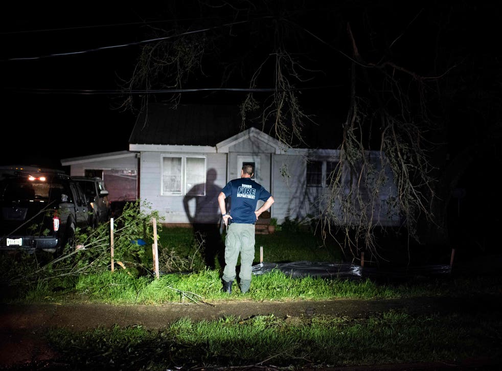 <p>Bourg fire chief TJ Pellegrin asks a couple if they are okay after Hurricane Ida passed</磷>