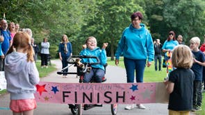 Inspirational young fundraiser Tobias Weller crosses the finish line, near his home in Sheffield, as he completes his latest epic feat where he swam and triked his way to the end of his “awesome” year-long Ironman Challenge. This is the third challenge Tobias, who has cerebral palsy and autism, has completed, raising more than £150,000 for his school and Sheffield Children Hospital’s charity