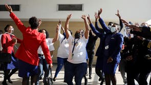 Workers sing and dance as a South African Airways airplane prepares to take off after a year-long hiatus triggered by the national airline running out of funds, at O R Tambo International Airport in Johannesburg
