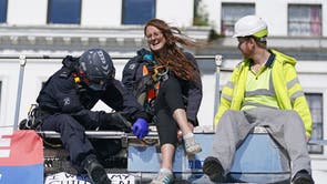  Police officers remove two protesters from the top of a tanker, as Insulate Britain block the A20 in Kent, which provides access to the Port of Dover in Kent. The environmental activists have moved location after been banned from campaigning on the M25 motorway in London