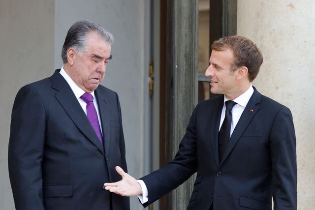 French President Emmanuel Macron (R) greets President of Tajikistan Emomali Rahmon at The Elysee Presidential Palace in Paris