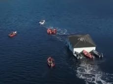 Video shows Canadian couple floating their 100-year-old dream house to new location
