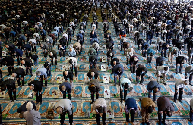 People gather in a mosque in the capital Tehran to perform the Friday prayers, for the first time after authorities eased some restrictions put in place for over a year in a bid to stem the spread of the coronavirus