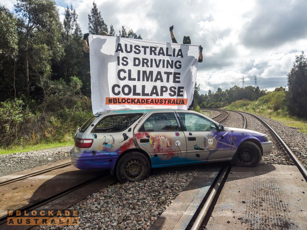 Climate activist barricades himself inside car at world’s largest coal port