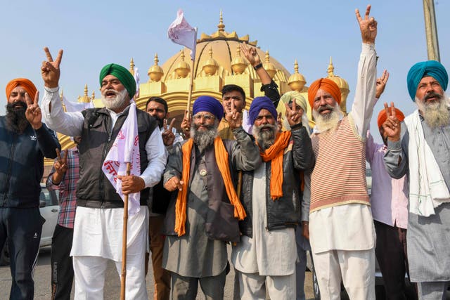 Farmers shout slogans to celebrate, after India’s Prime Minister announced to repeal three agricultural reform laws that sparked almost a year of huge protests across the country, in Amritsar
