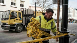 Clean up crews work down Main St after Police have finished gathering evidence in Waukesha, Wisconsin after a driver rammed into a Christmas parade in the town on Sunday evening, killing at least five people and injuring 48 others