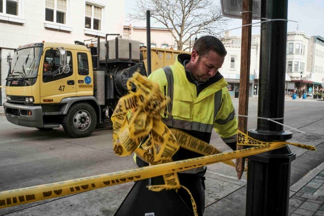 Clean up crews work down Main St after Police have finished gathering evidence in Waukesha, Wisconsin after a driver rammed into a Christmas parade in the town on Sunday evening, killing at least five people and injuring 48 others