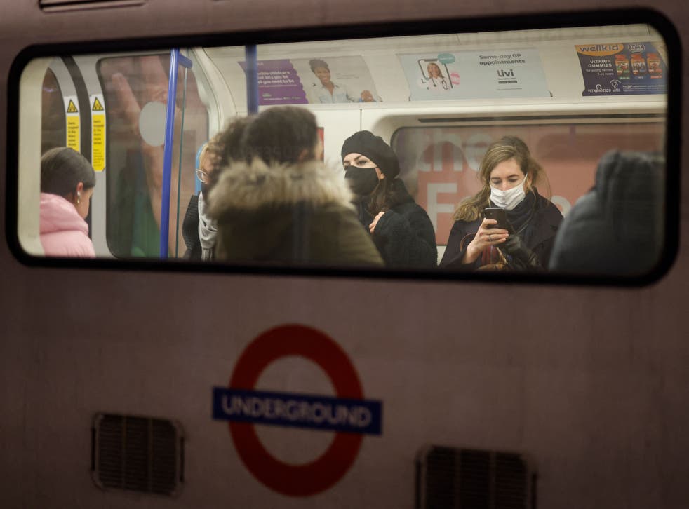 <p>Passengers, many wearing face coverings to combat the spread of Covid-19, travel on the London underground in central London on 28 November 2021</s>