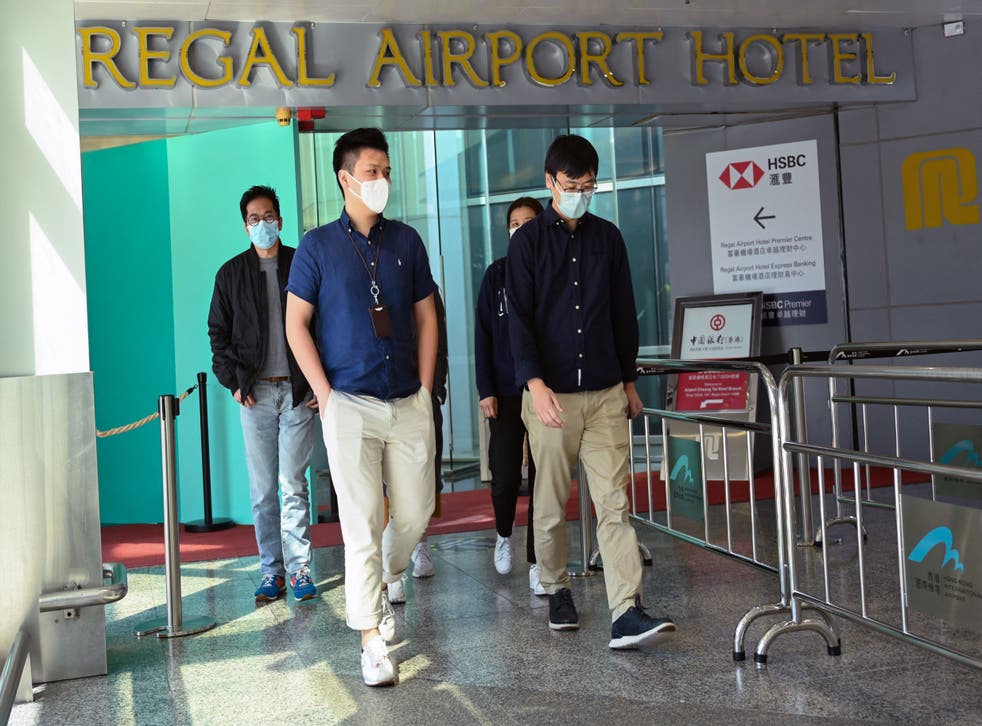 <p>People leave the Regal Airport Hotel at Chek Lap Kok airport in Hong Kong on 26 November 2021, where a new Covid-19 variant deemed a ‘major threat’ </p>