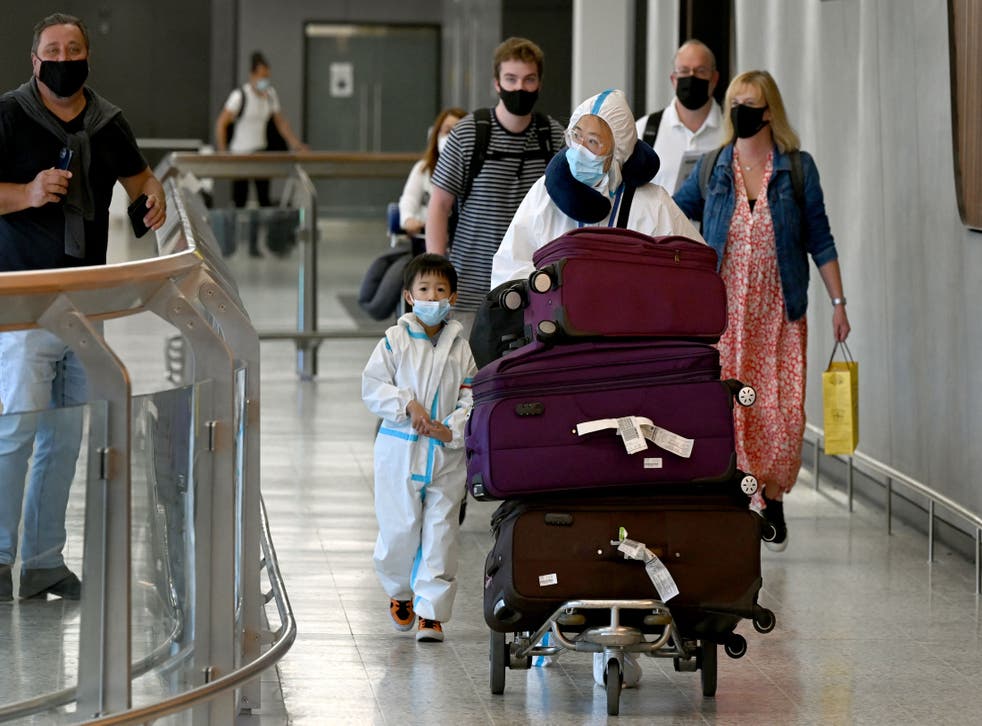 <p>International travellers wearing personal protective equipment (PPE) arrive at Melbourne’s Tullamarine Airport on 29 November 2021</p>