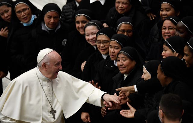 Pope Francis salutes nuns at the end of his general audience at Paul VI Hall at the Vatican