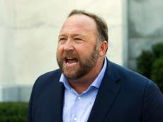 Why is Alex Jones being sued by families of children killed in Sandy Hook massacre?