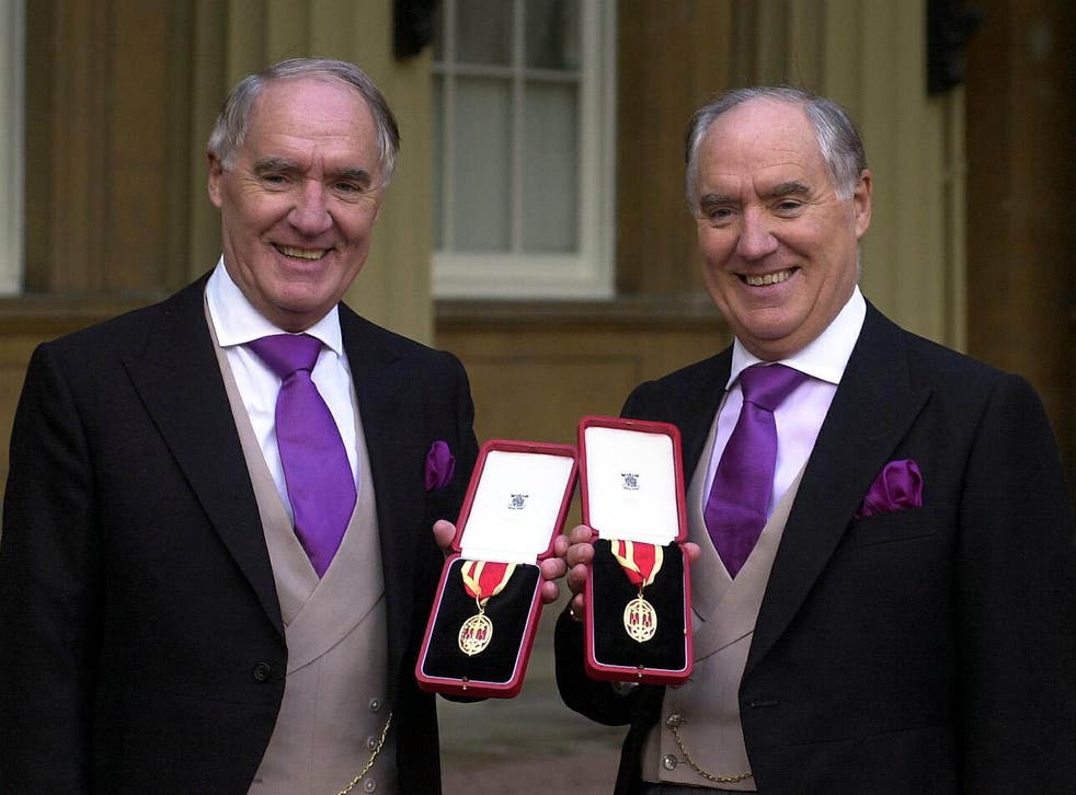 Sir Frederick Barclay, reg, and twin brother Sir David after receiving their knighthoods in 2000 (Michael Stephens/PA)
