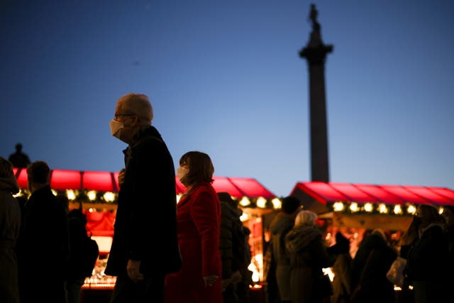 Mense stap deur 'n Kersmark in Trafalgar Square