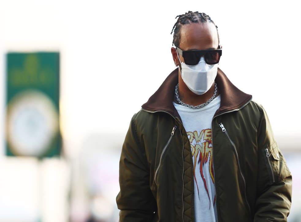<p>Lewis Hamilton of Great Britain and Mercedes GP walks in the Paddock</p>