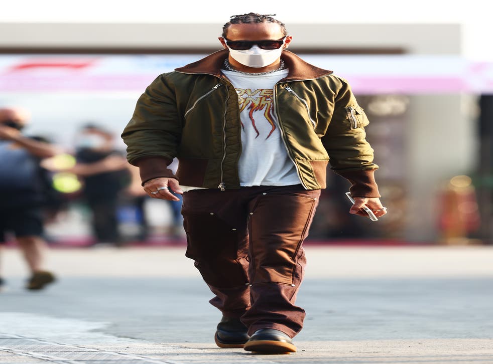<p>Lewis Hamilton of Great Britain and Mercedes GP walks in the Paddock</p>