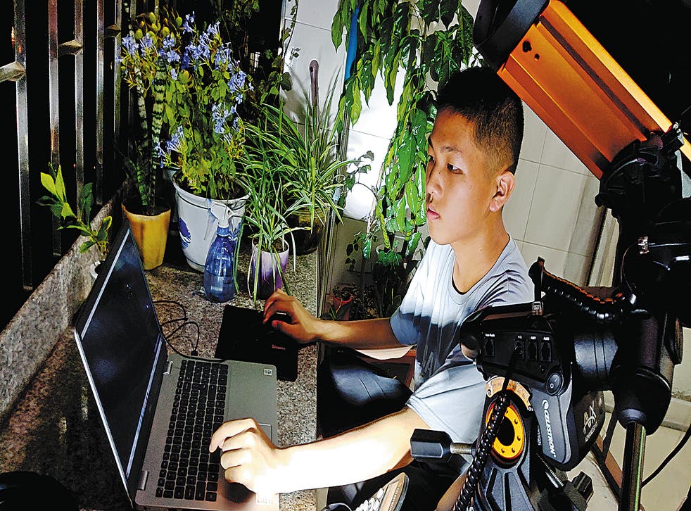 <p> Wang takes photos from the balcony of his home in Yongtai county, Fujian province   </磷>