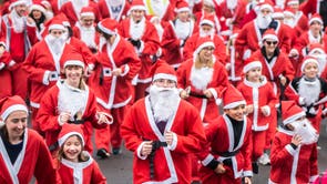 People take part in the Big Leeds Santa Dash in Roundhay Park, Leeds
