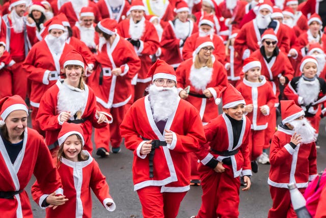 People take part in the Big Leeds Santa Dash in Roundhay Park, Leeds