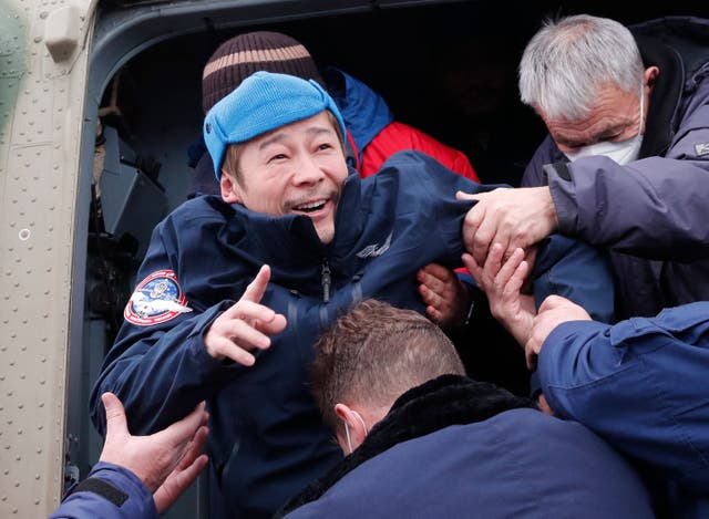 Japanese billionaire Yusaku Maezawa disembarks from a helicopter after returning from the International Space Station (ISS)