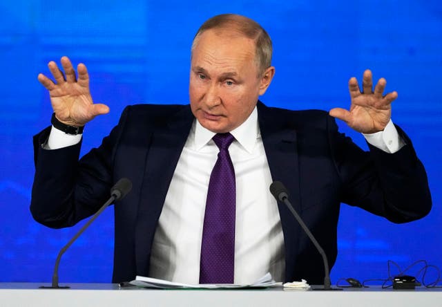 Russian President Vladimir Putin gestures while speaking during his annual news conference in Moscow