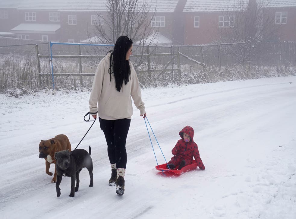 <p>A woman pulls a child through the snow on a sledge in Tow Law, County Durham. Parts of England from the East Midlands to the North-East have joined Scotland in preparing for blizzard-like conditions on Boxing Day as the white Christmas continues.</p>