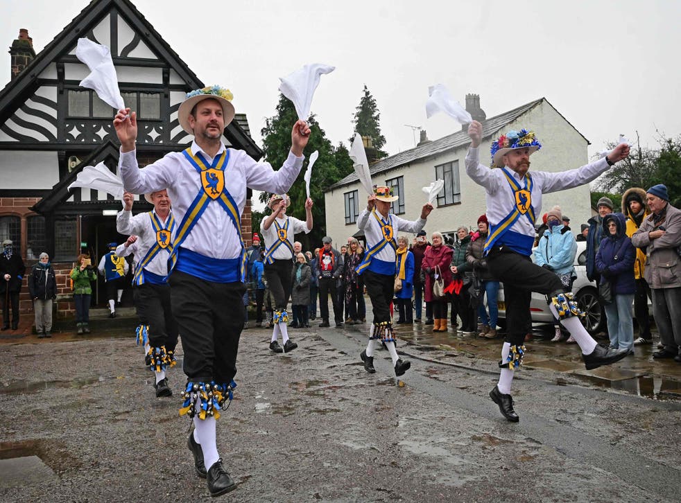 <p>Members of the Mersey Morris Men take part in their Boxing Day Morris dance in Willaston, north west England on December 26, 2021.</p>