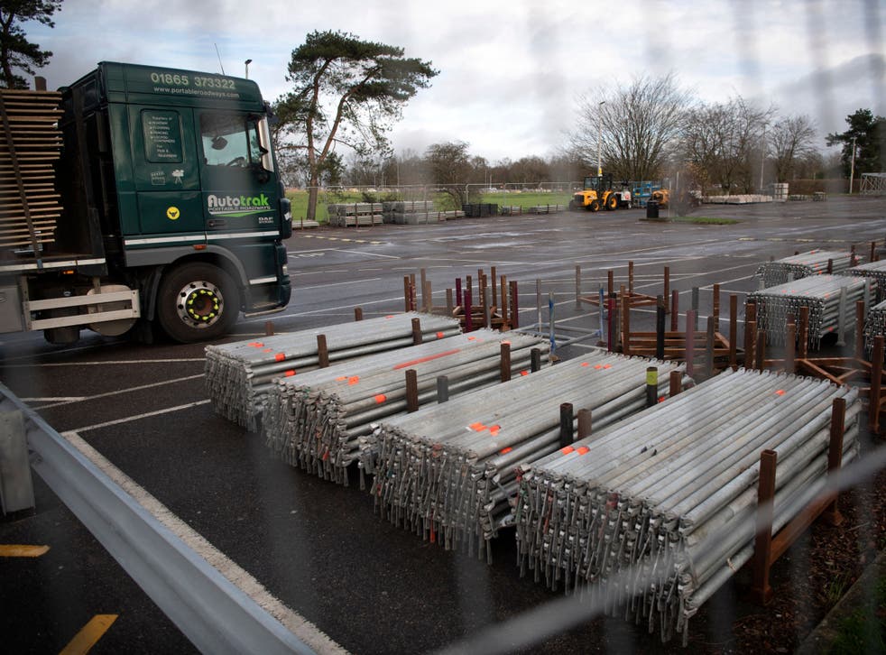 <p>A temporary field hospital is seen taking place in the grounds of The William Harvey Hospital, in Ashford, Kent</p>