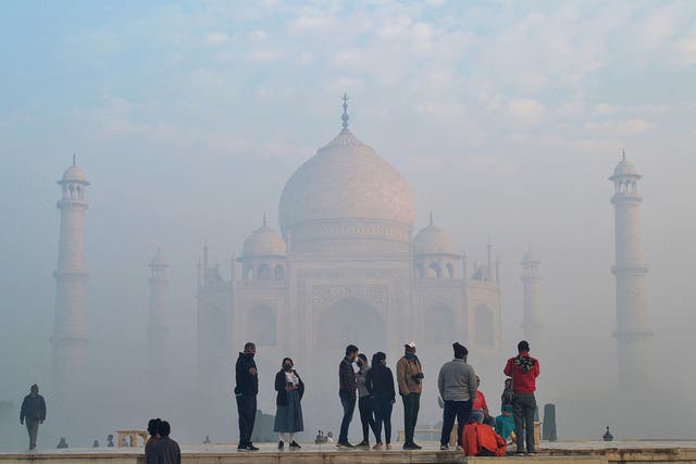 Tourists visit the Taj Mahal amidst fog in Agra