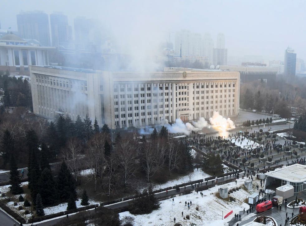 <p>Smoke rises from the city hall building during a protest in Almaty</p>