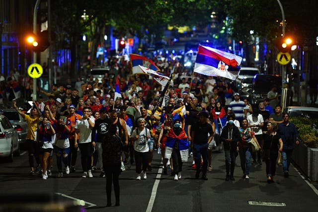 Members of the Serbian community march in Melbourne, 澳大利亚, in support of tennis player Novak Djokovic, who was being kept in an immigration detention center after his visa was revoked upon landing in the country