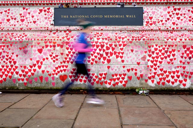 ’n Joggie ry verby die Covid Memorial Wall in Londen