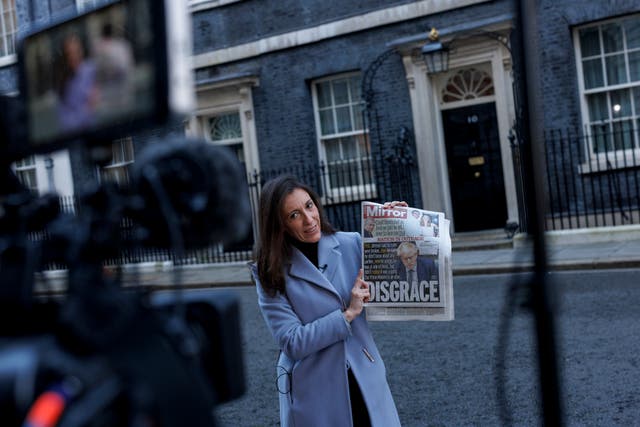 A TV presenter holds a copy of a newspaper outside 10 Downing Streetafter the Prime Minister apologised for attending a gathering of colleagues in the Number Ten garden in May 2020, while the UK was in strict lockdown due to the Coronavirus pandemic