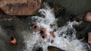 Hindu devotees take a dip in the waters of river Narmada in Budhni, on the occasion of Makar Sankranti, a day considered to be of great religious significance in Hindu mythology